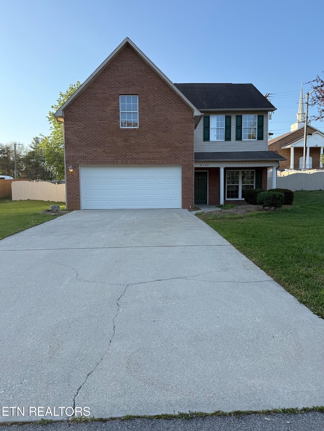 view of front of home featuring an attached garage, fence, driveway, and a front lawn