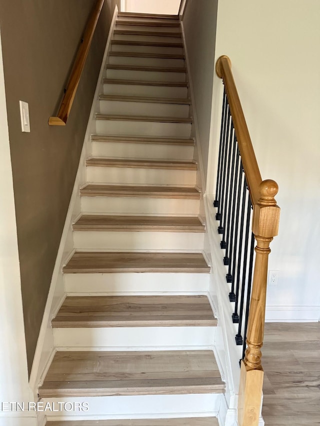 stairway with wood finished floors