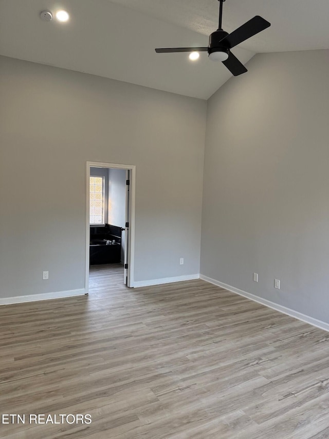 spare room with baseboards, a ceiling fan, light wood-style floors, recessed lighting, and lofted ceiling