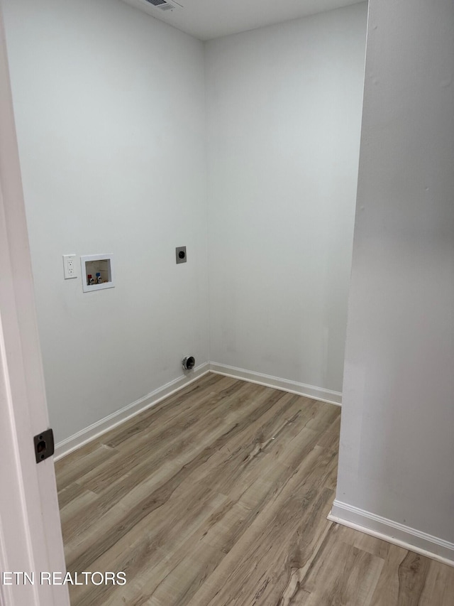 laundry room featuring laundry area, electric dryer hookup, wood finished floors, washer hookup, and baseboards