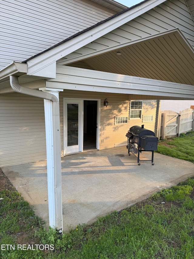 view of patio with fence and area for grilling