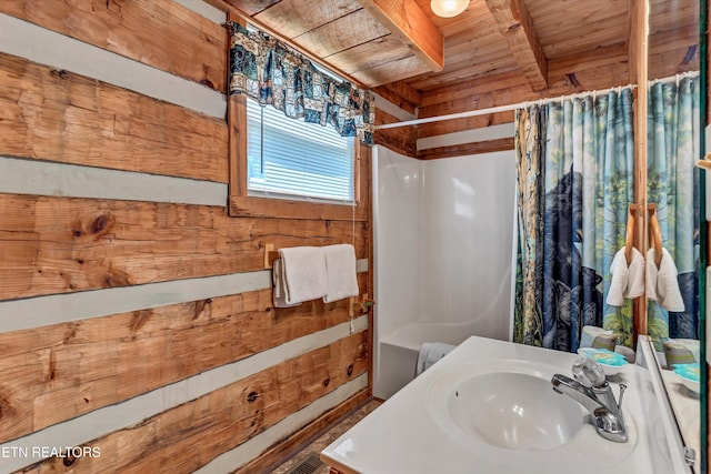 2580 Black Bear Ln, Sevierville, TN 37876 - bathroom with beam ceiling, shower / bathtub combination with curtain, wooden ceiling, and a sink