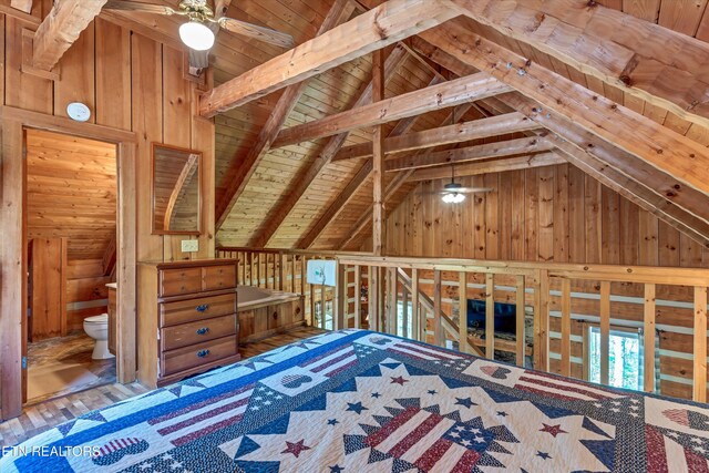 2580 Black Bear Ln, Sevierville, TN 37876 - unfurnished bedroom featuring lofted ceiling with beams, wooden walls, wooden ceiling, and connected bathroom