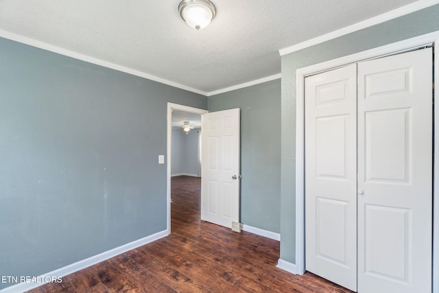 369 Robertsville Rd, Oak Ridge, TN 37830 - unfurnished bedroom with crown molding, a closet, baseboards, wood finished floors, and a textured ceiling