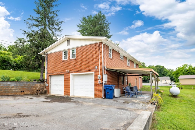 7324 Thorn Grove Pike, Knoxville, TN 37914 - view of side of property featuring brick siding, a yard, an attached garage, and asphalt driveway