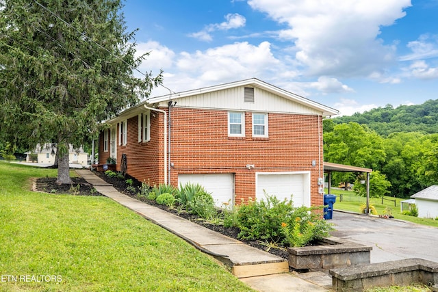 7324 Thorn Grove Pike, Knoxville, TN 37914 - view of property exterior with a garage, brick siding, asphalt driveway, and a lawn