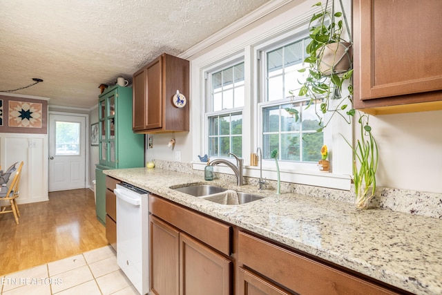 7324 Thorn Grove Pike, Knoxville, TN 37914 - kitchen featuring a sink, dishwasher, brown cabinetry, a textured ceiling, and light stone counters