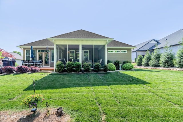 169 Dudi Trl, Vonore, TN 37885 - back of house featuring a lawn, roof with shingles, and a sunroom