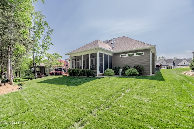 169 Dudi Trl, Vonore, TN 37885 - back of property featuring a yard, a sunroom, and roof with shingles