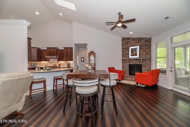 169 Dudi Trl, Vonore, TN 37885 - dining area featuring ceiling fan, a fireplace, dark wood-type flooring, visible vents, and recessed lighting