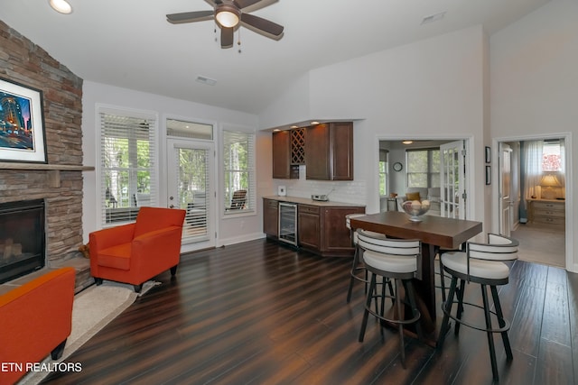 169 Dudi Trl, Vonore, TN 37885 - dining area with dark wood-style floors, plenty of natural light, ceiling fan, a stone fireplace, and beverage cooler