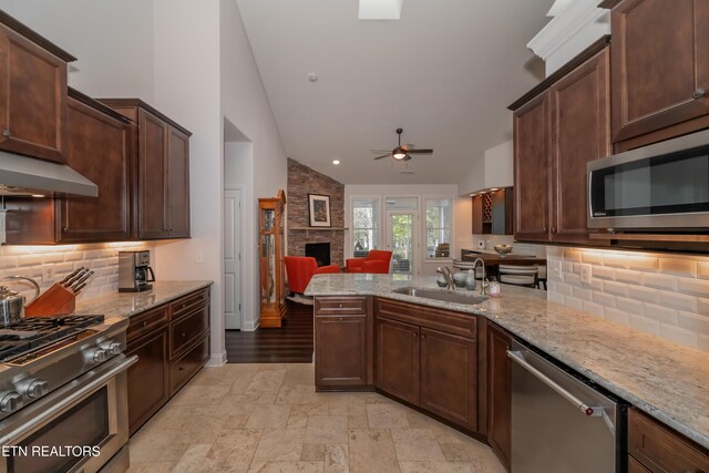169 Dudi Trl, Vonore, TN 37885 - kitchen featuring range hood, a stone fireplace, a sink, appliances with stainless steel finishes, and ceiling fan