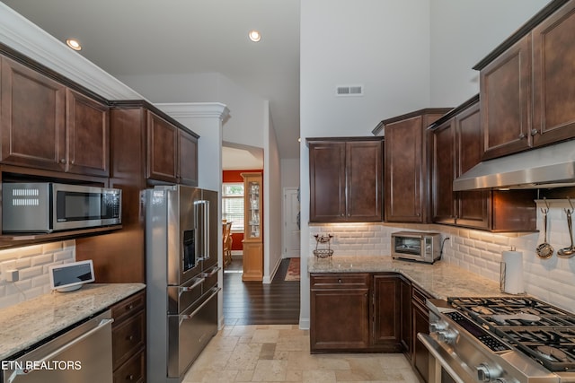 169 Dudi Trl, Vonore, TN 37885 - kitchen featuring light stone countertops, under cabinet range hood, appliances with stainless steel finishes, and visible vents