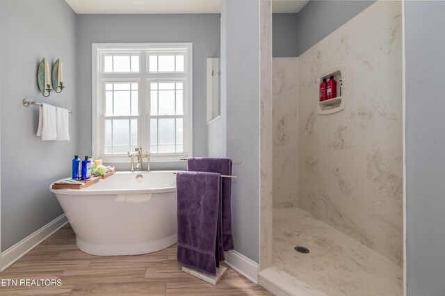 169 Dudi Trl, Vonore, TN 37885 - full bathroom featuring baseboards, a freestanding tub, and a wealth of natural light