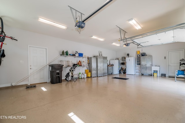 169 Dudi Trl, Vonore, TN 37885 - garage featuring a garage door opener and freestanding refrigerator