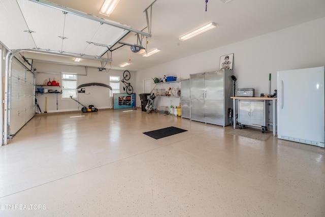 169 Dudi Trl, Vonore, TN 37885 - garage with freestanding refrigerator and a garage door opener
