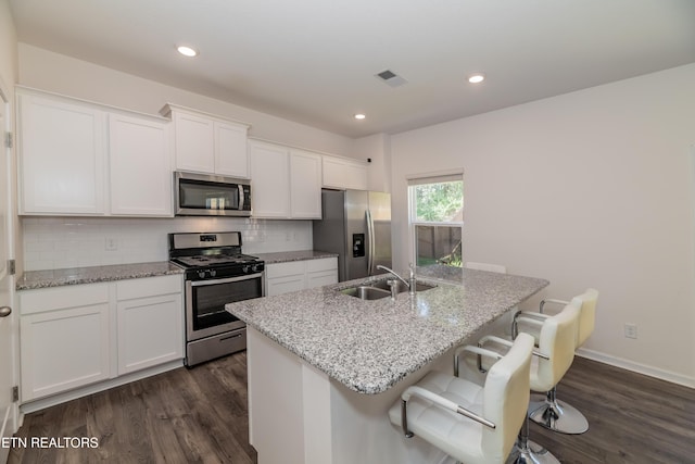 2740 Red Barn Rd, Knoxville, TN 37931 - kitchen with visible vents, white cabinets, a sink, a kitchen island with sink, and stainless steel appliances
