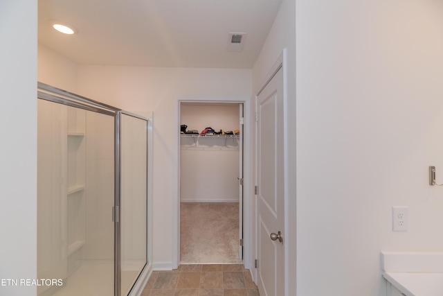 2740 Red Barn Rd, Knoxville, TN 37931 - bathroom with visible vents, a spacious closet, and a stall shower