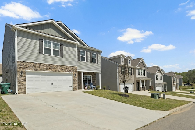 craftsman inspired home with a residential view, driveway, stone siding, a garage, and board and batten siding