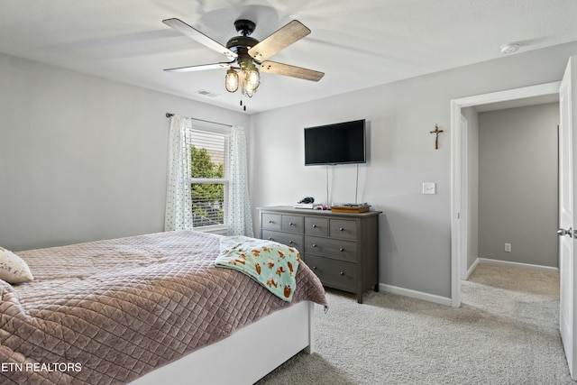 bedroom featuring visible vents, carpet flooring, baseboards, and a ceiling fan