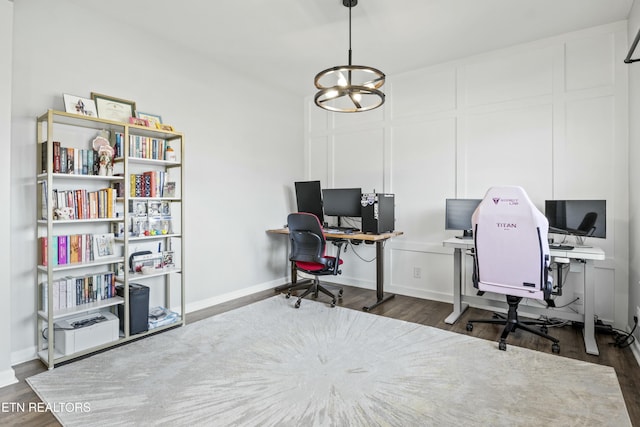 home office featuring a chandelier, baseboards, and dark wood finished floors