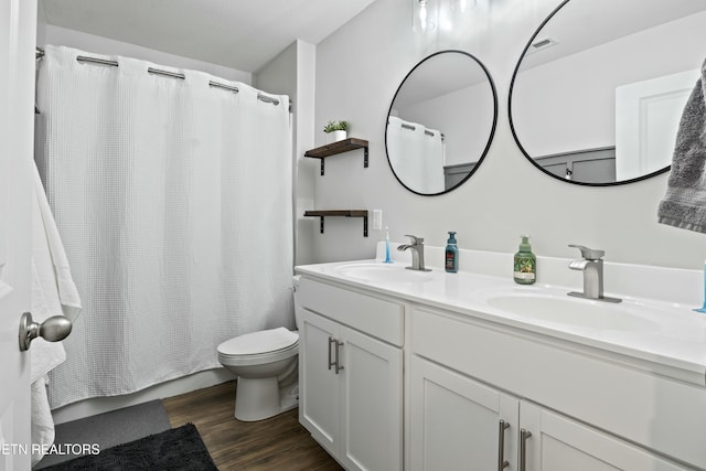 full bath with toilet, wood finished floors, a sink, and visible vents
