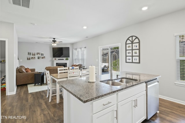 kitchen with dark wood-style floors, a sink, visible vents, ceiling fan, and dishwasher