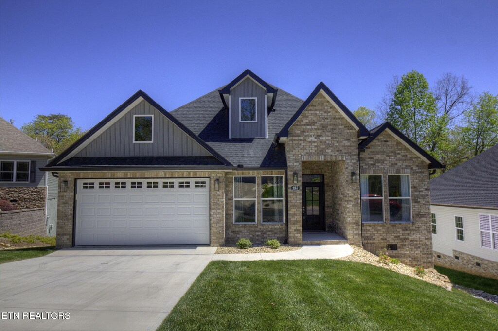 153 Daleyuhski Way, Loudon, TN 37774 - craftsman-style home featuring a shingled roof, concrete driveway, board and batten siding, brick siding, and a front yard