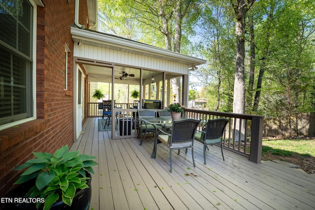 wooden terrace featuring outdoor dining area and ceiling fan