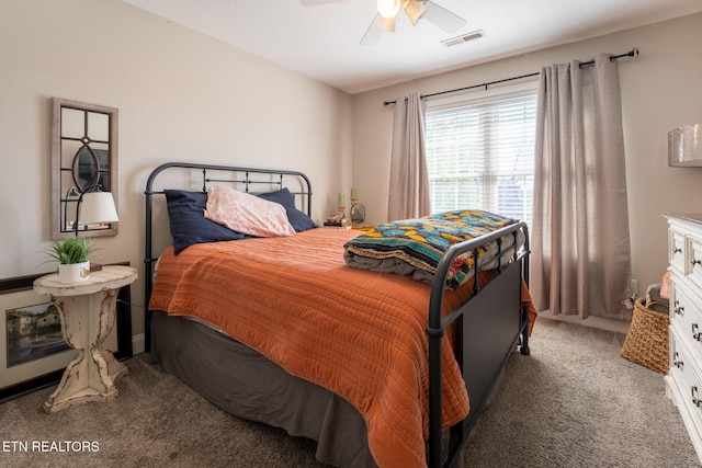 bedroom with ceiling fan, visible vents, and light carpet