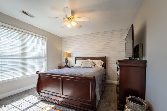 bedroom featuring ceiling fan, baseboards, visible vents, and light carpet