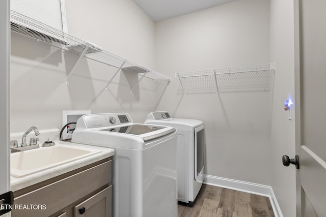 2718 Vista Meadows Ln, Sevierville, TN 37876 - washroom with washing machine and dryer, dark wood finished floors, cabinet space, a sink, and baseboards