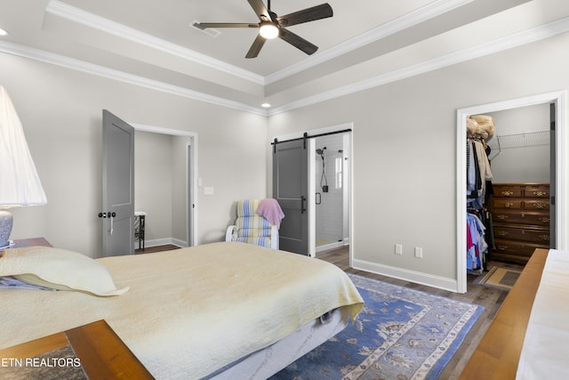 2718 Vista Meadows Ln, Sevierville, TN 37876 - bedroom featuring a barn door, ornamental molding, wood finished floors, and a raised ceiling
