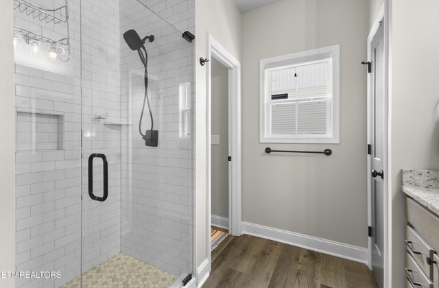2718 Vista Meadows Ln, Sevierville, TN 37876 - bathroom featuring vanity, baseboards, wood finished floors, and a stall shower