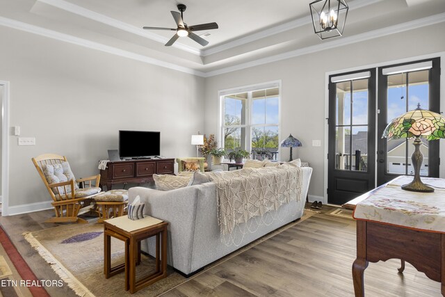2718 Vista Meadows Ln, Sevierville, TN 37876 - living room featuring crown molding, a tray ceiling, wood finished floors, and ceiling fan with notable chandelier