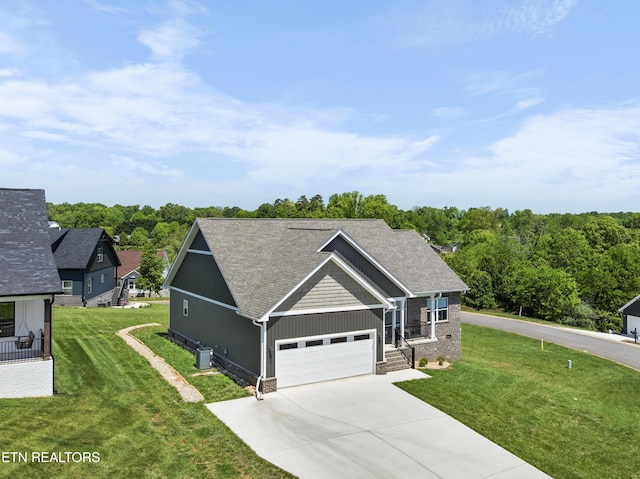 2718 Vista Meadows Ln, Sevierville, TN 37876 - craftsman-style house with driveway, a shingled roof, a front yard, and cooling unit