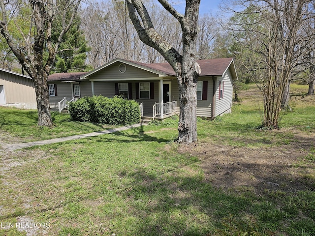 1009 Roysden Rd, Jamestown, TN 38556 - view of front of house with roof with shingles, covered porch, and a front lawn
