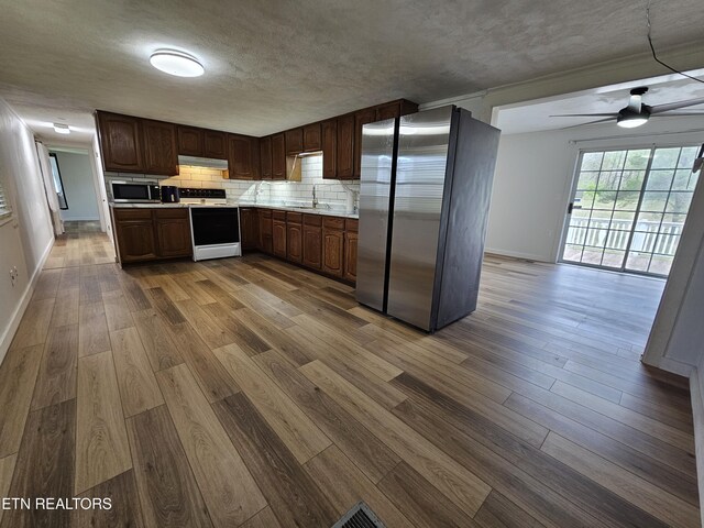1009 Roysden Rd, Jamestown, TN 38556 - kitchen featuring light countertops, appliances with stainless steel finishes, baseboards, and dark wood finished floors