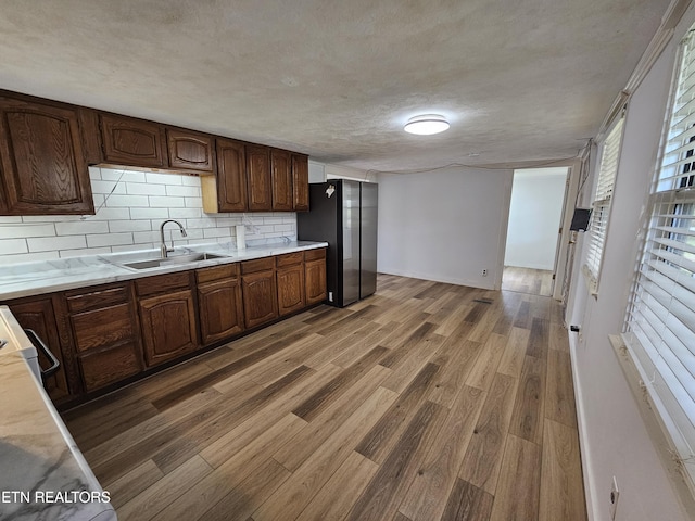 1009 Roysden Rd, Jamestown, TN 38556 - kitchen featuring a sink, light countertops, freestanding refrigerator, and light wood finished floors