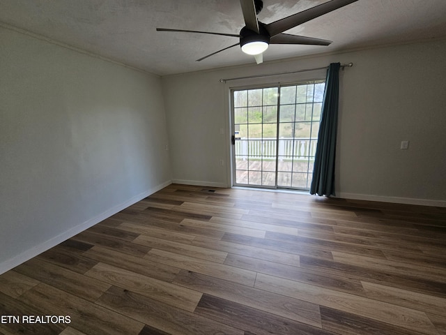 1009 Roysden Rd, Jamestown, TN 38556 - unfurnished room with dark wood-type flooring, baseboards, and ceiling fan