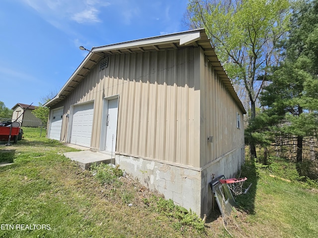 1009 Roysden Rd, Jamestown, TN 38556 - view of home's exterior featuring a yard, a garage, fence, and an outbuilding