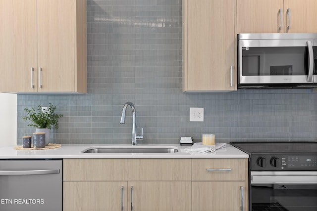 105 E Oldham Ave Unit 103, Knoxville, TN 37917 - kitchen with appliances with stainless steel finishes, a sink, light brown cabinetry, and tasteful backsplash