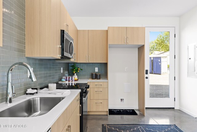 105 E Oldham Ave Unit 103, Knoxville, TN 37917 - kitchen with stainless steel microwave, light brown cabinets, a sink, finished concrete flooring, and range with electric cooktop