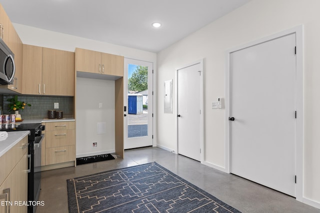105 E Oldham Ave Unit 103, Knoxville, TN 37917 - kitchen with black / electric stove, light brown cabinetry, decorative backsplash, finished concrete floors, and light countertops