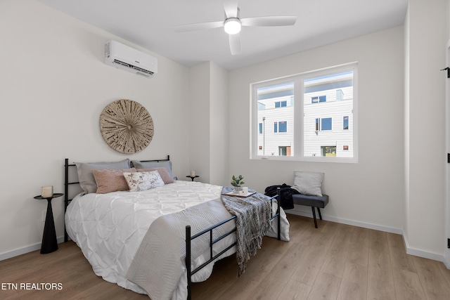 105 E Oldham Ave Unit 103, Knoxville, TN 37917 - bedroom with a wall unit AC, light wood finished floors, baseboards, and ceiling fan