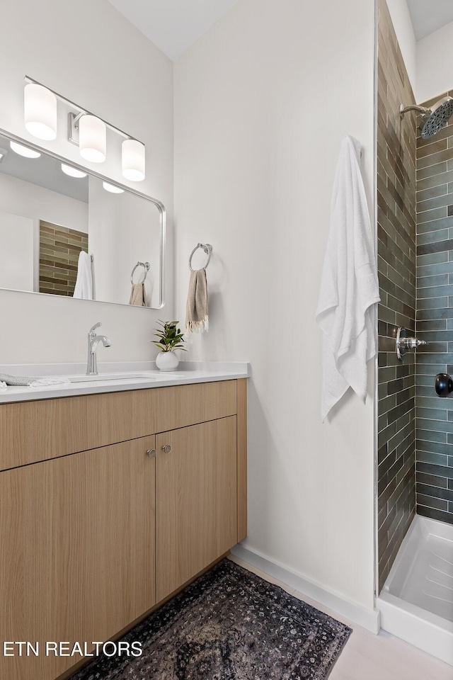 105 E Oldham Ave Unit 103, Knoxville, TN 37917 - full bath featuring a stall shower, vanity, and baseboards