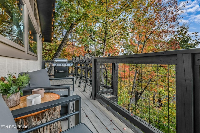wooden deck with a grill