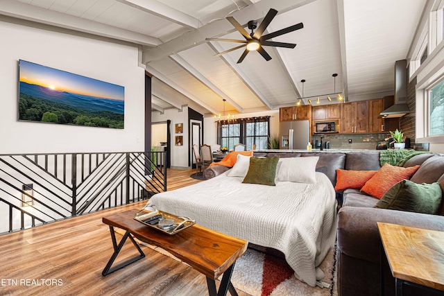 bedroom with light wood-type flooring, vaulted ceiling with beams, stainless steel fridge, and a notable chandelier