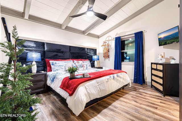 bedroom featuring lofted ceiling with beams, wood finished floors, and ceiling fan
