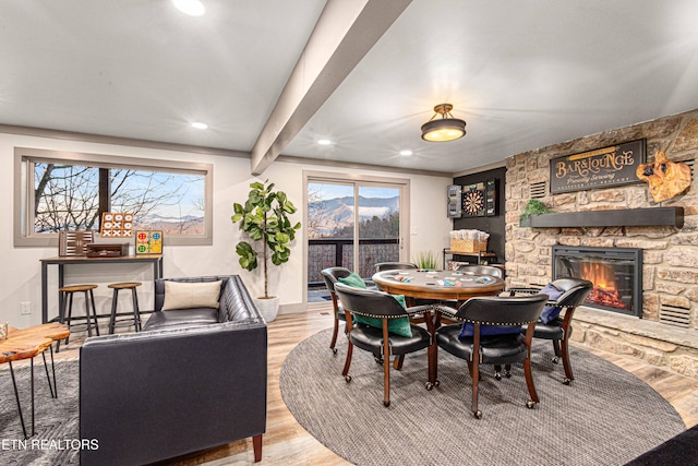 dining area featuring plenty of natural light, recessed lighting, wood finished floors, and a fireplace